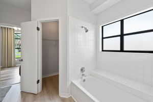 Primary Bathroom Showing Tub and Walk In Closet