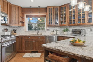 Kitchen with 6 Burner Gas Stove and Custom Cabinets