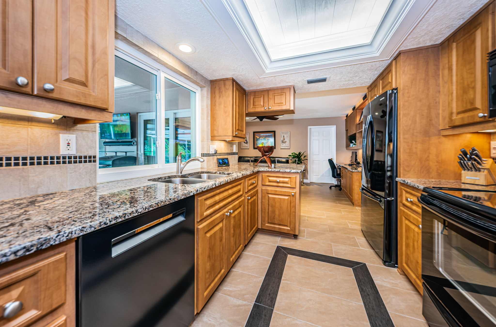 Kitchen into family room - beautiful backyard view!