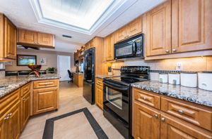 Kitchen extends into family room with matching built-in cabinetry.