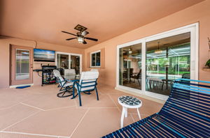 Impact Sliders lead to the covered patio. Perfect for relaxing or entertaining.  TV & Sound Bar convey.