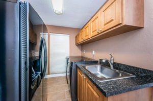 Laundry Room - spacious with lots of storage. Additional fridge conveys.