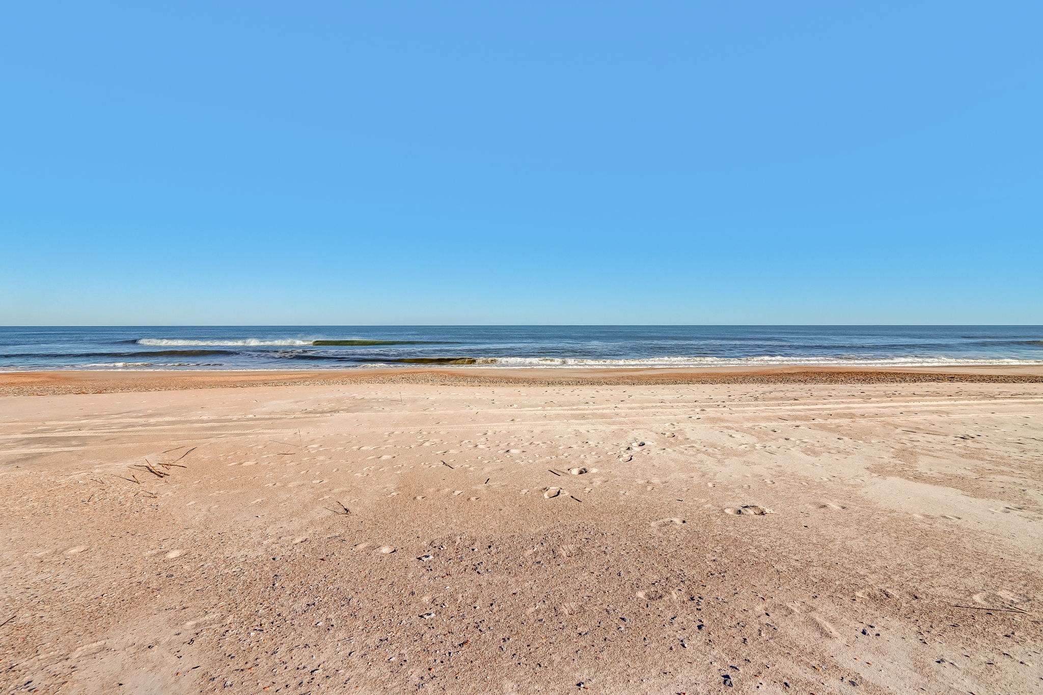 ...all overlooking a wide, quiet stretch of beach and open blue water.