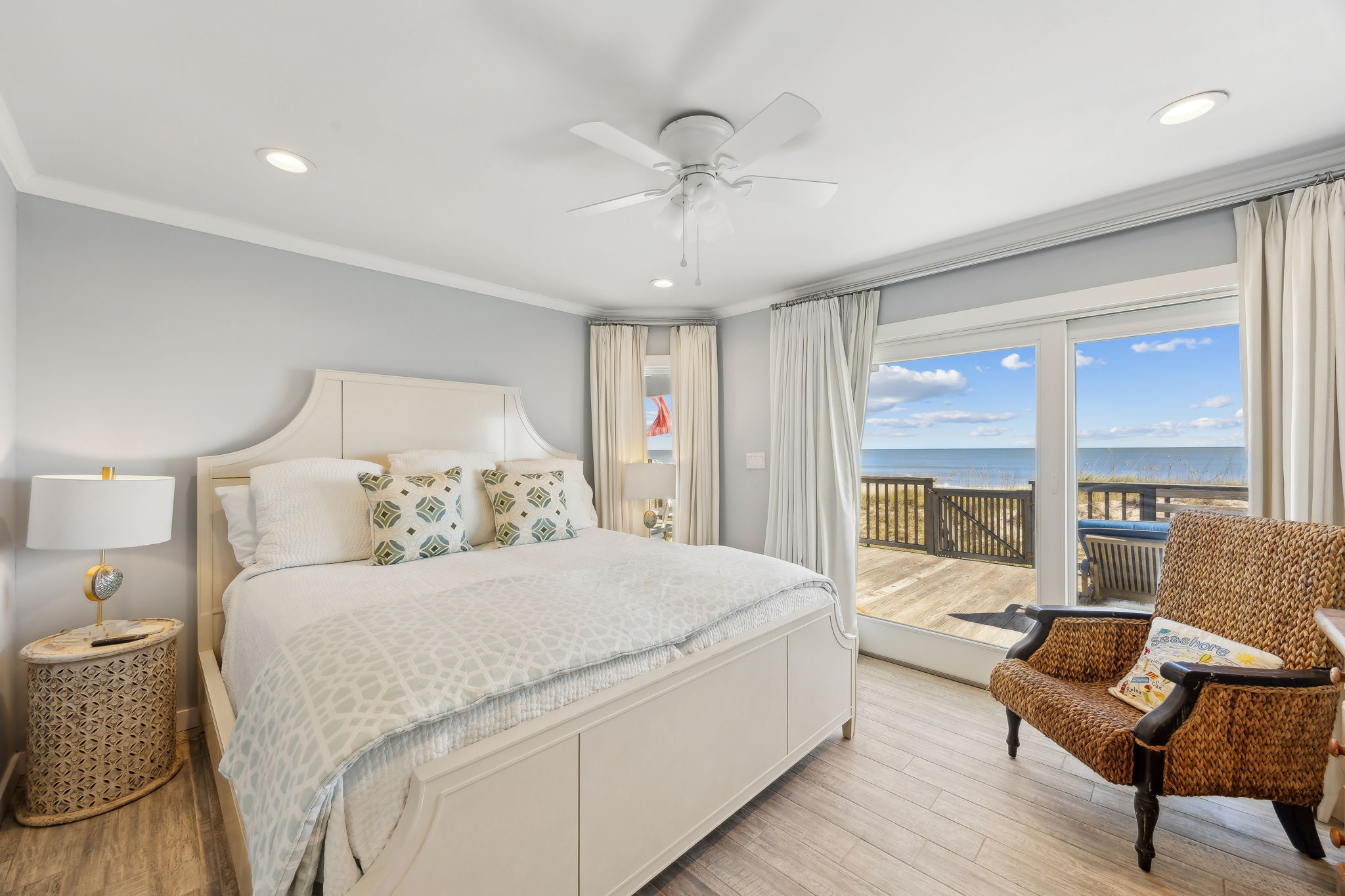 The primary suite brings the ocean even closer, with soft coastal layers and direct deck access...