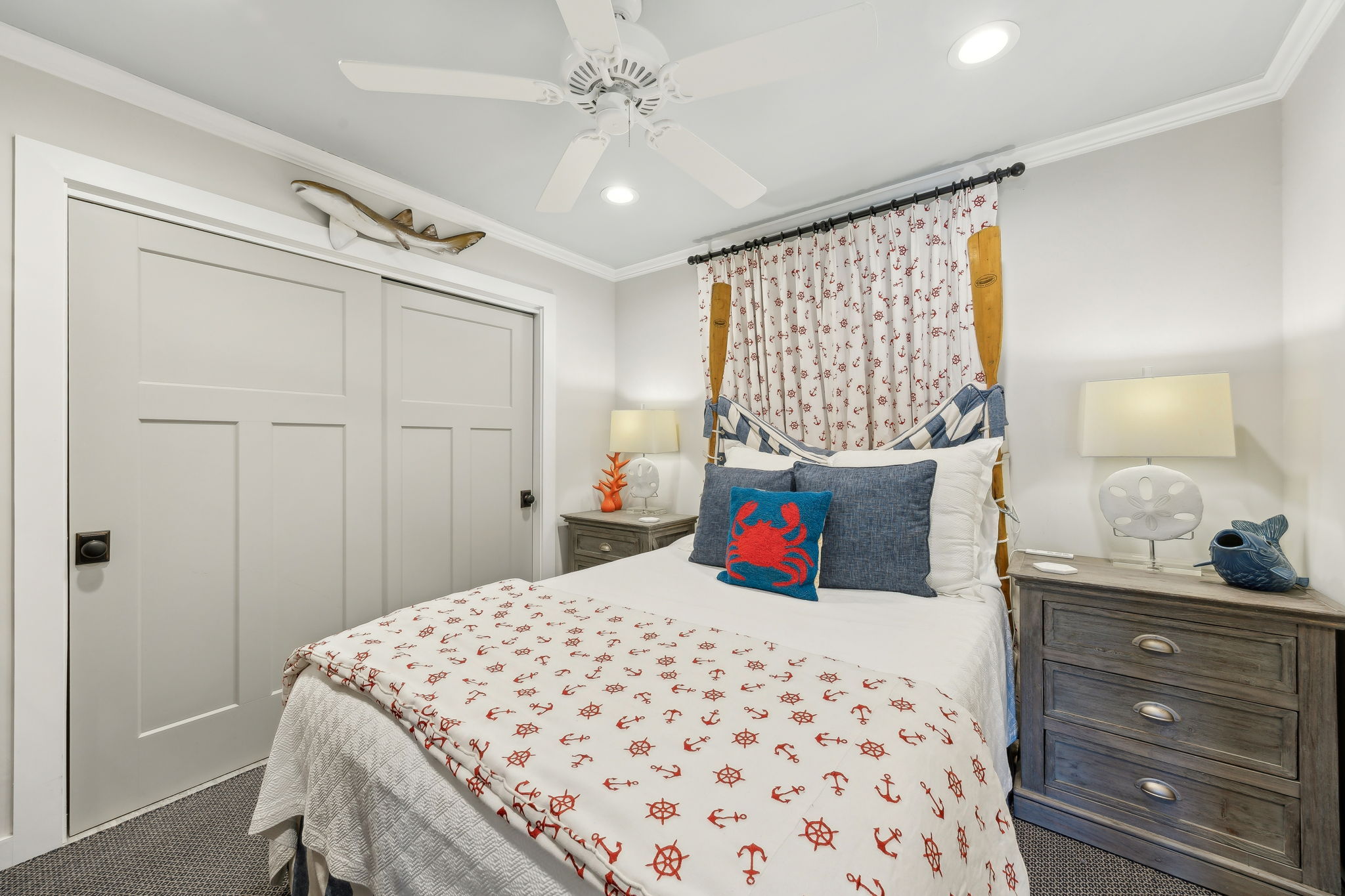 A second guest bedroom carries the coastal personality forward with bold nautical accents...