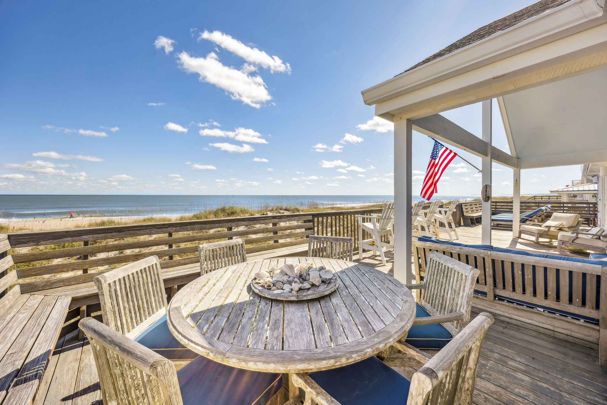 Outside, the deck becomes another living room — open to the breeze, the dunes, and the water beyond...
