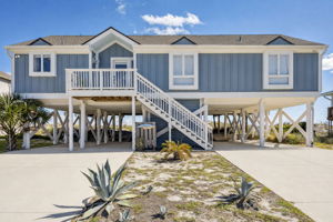 Oceanfront living begins here — an elevated beach home with covered parking for 4+ vehicles...
