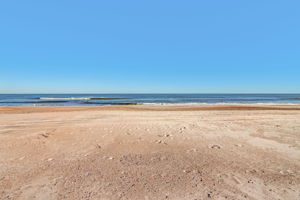 ...all overlooking a wide, quiet stretch of beach and open blue water.