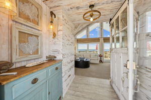 Step inside to a warm coastal welcome, where texture, light, and ocean views draw you in...