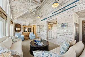 ...leading into a soaring great room wrapped in white-washed cypress walls and ceilings...