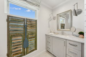 ...balanced by vintage shutters, thoughtful lighting, and a collected beach-house feel.