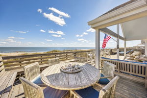 Outside, the deck becomes another living room — open to the breeze, the dunes, and the water beyond...