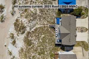 From above, the setting tells the story — ocean, dunes, deck, and home all connected without interruption.
