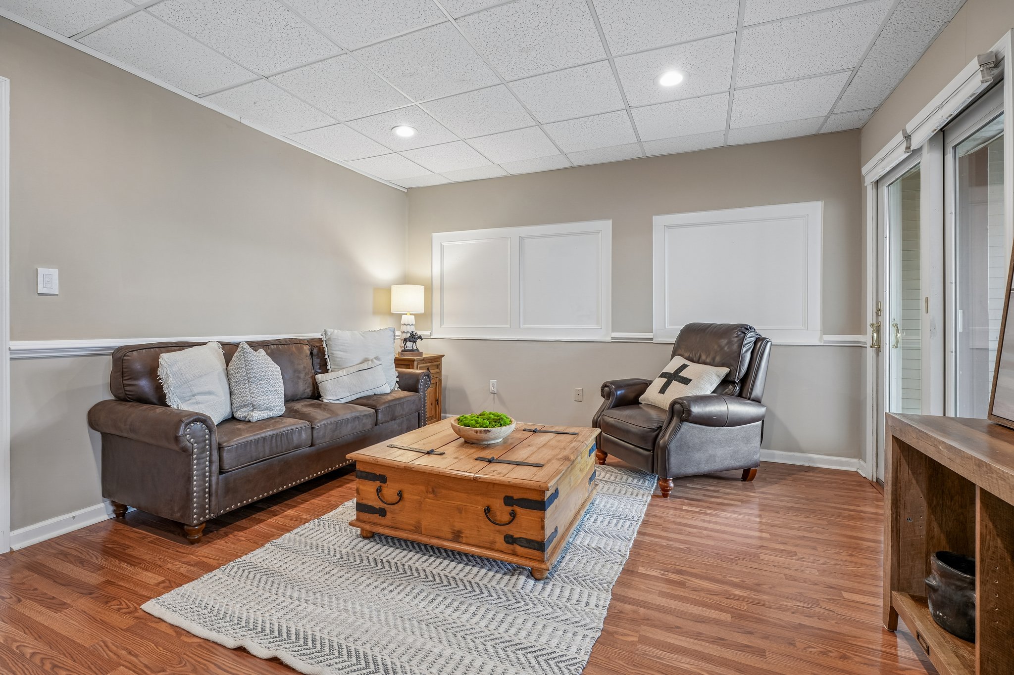 Set up as a lower level sitting area, could also be a bedroom or office.