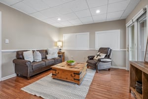 Set up as a lower level sitting area, could also be a bedroom or office.