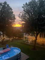 As the sun dips, the backyard comes alive - string lights twinkling, the pool glowing (not included with purchase), and just enough magic in the air to keep everyone outside a little longer.