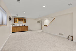 Fully finished basement with bar and sink