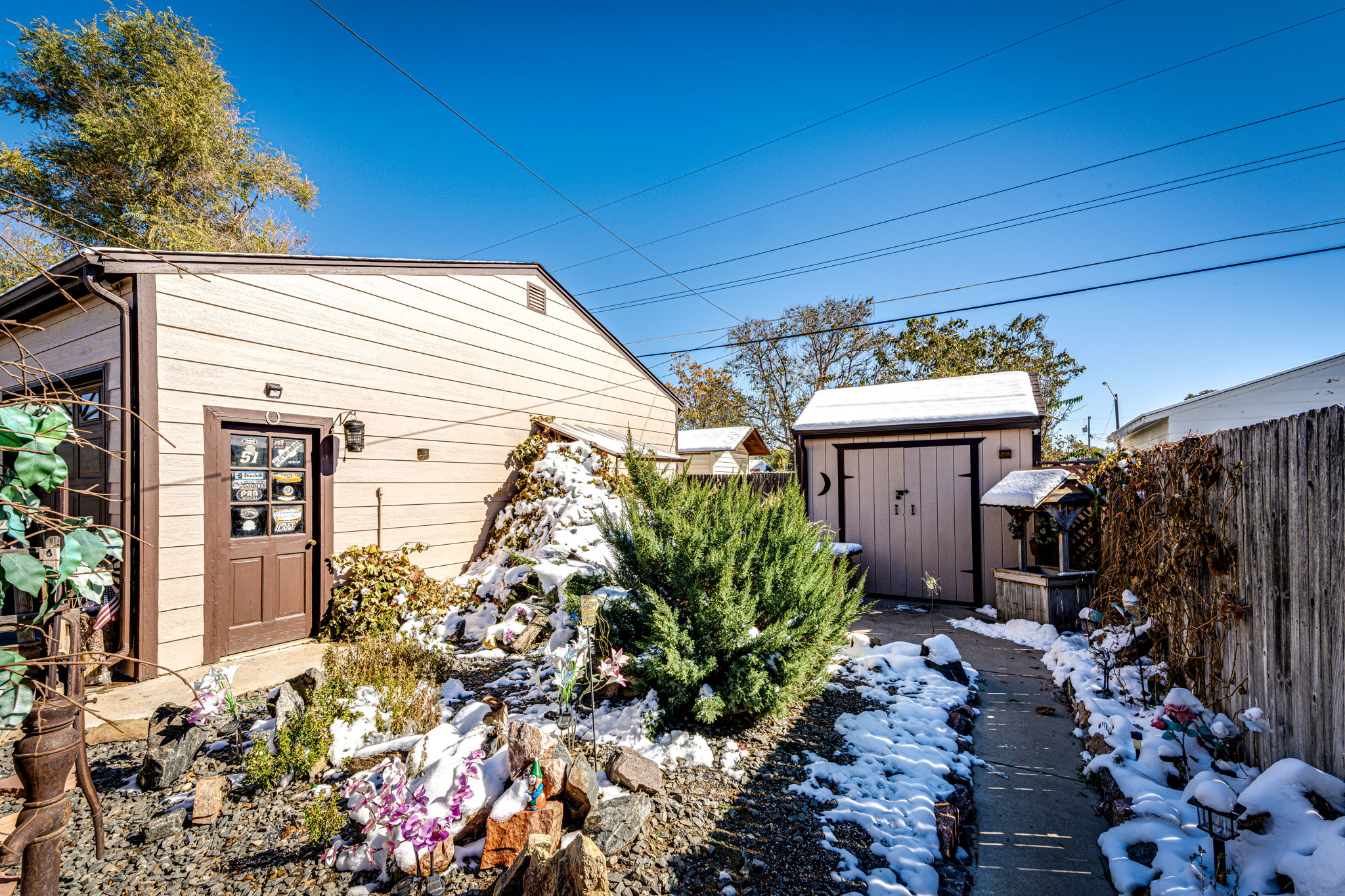 View of the backyard shed and side entrance into the garage