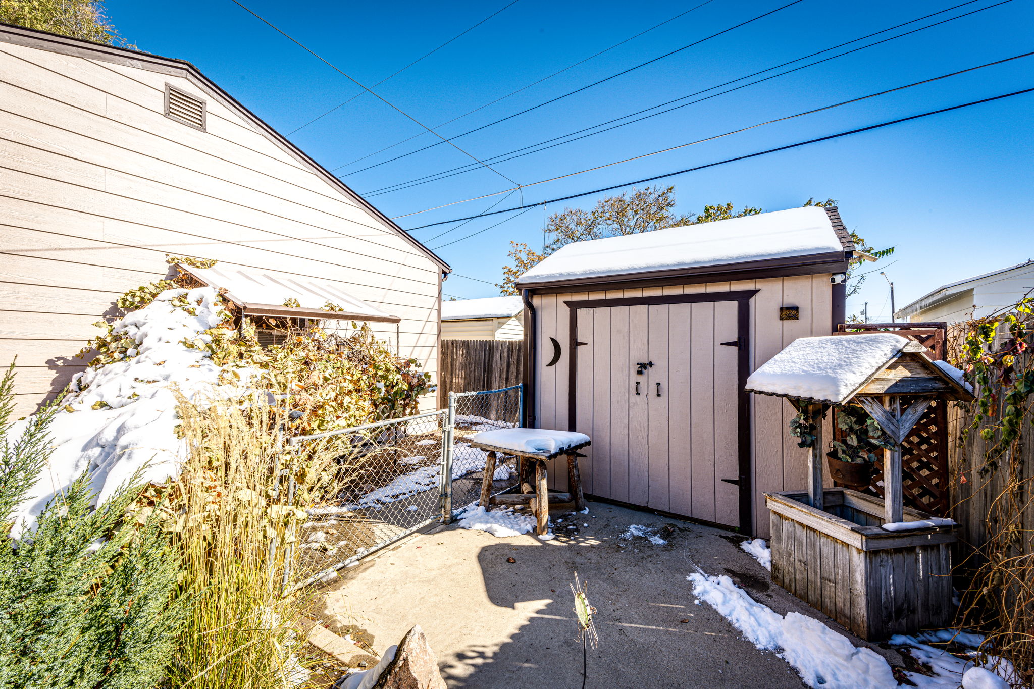 As you look at the shed, the dog run is on the left side and goes behind the garage