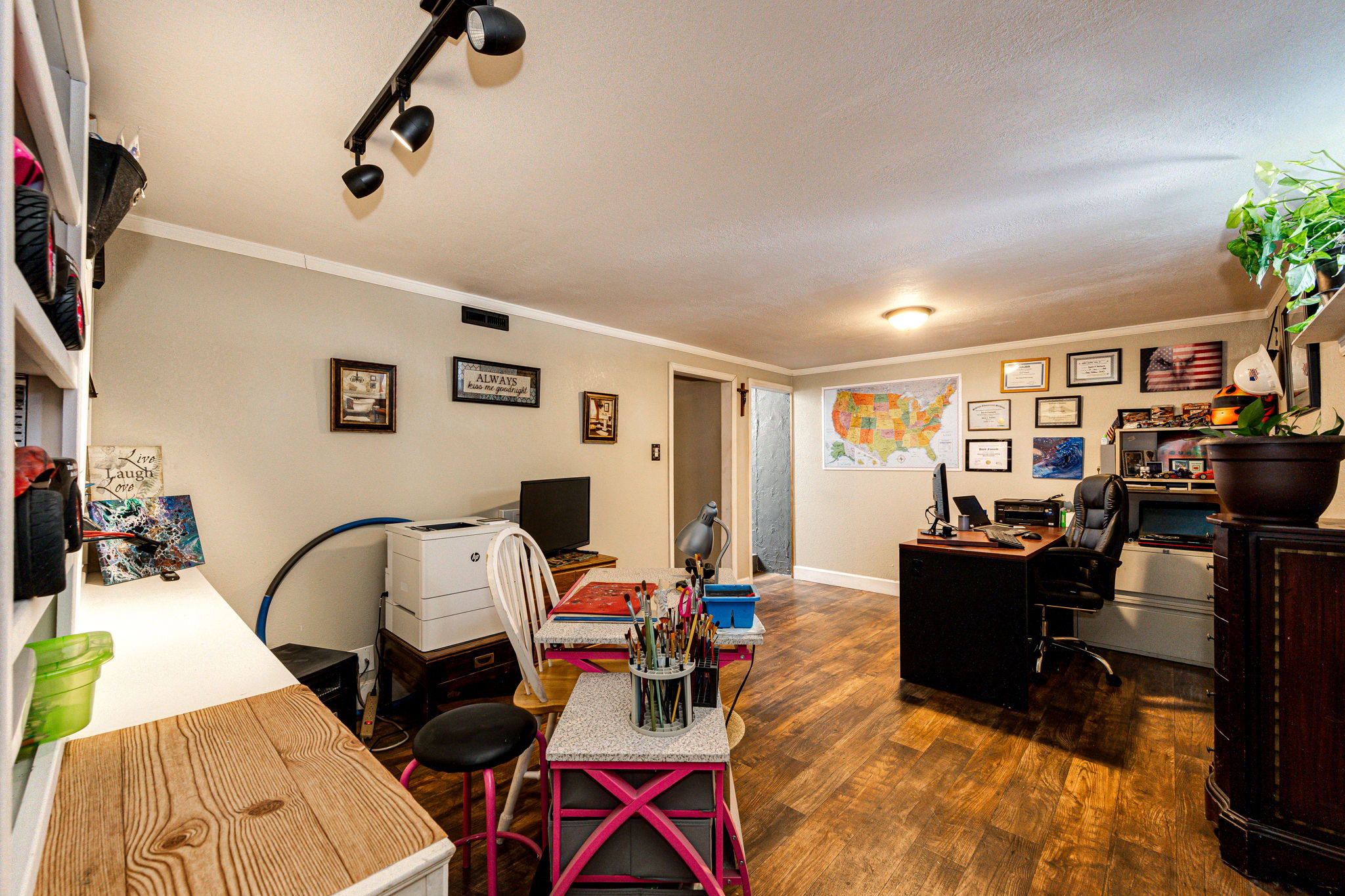 Basement family room area currently being used as a office & craft area