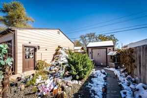 View of the backyard shed and side entrance into the garage