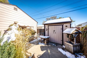 As you look at the shed, the dog run is on the left side and goes behind the garage