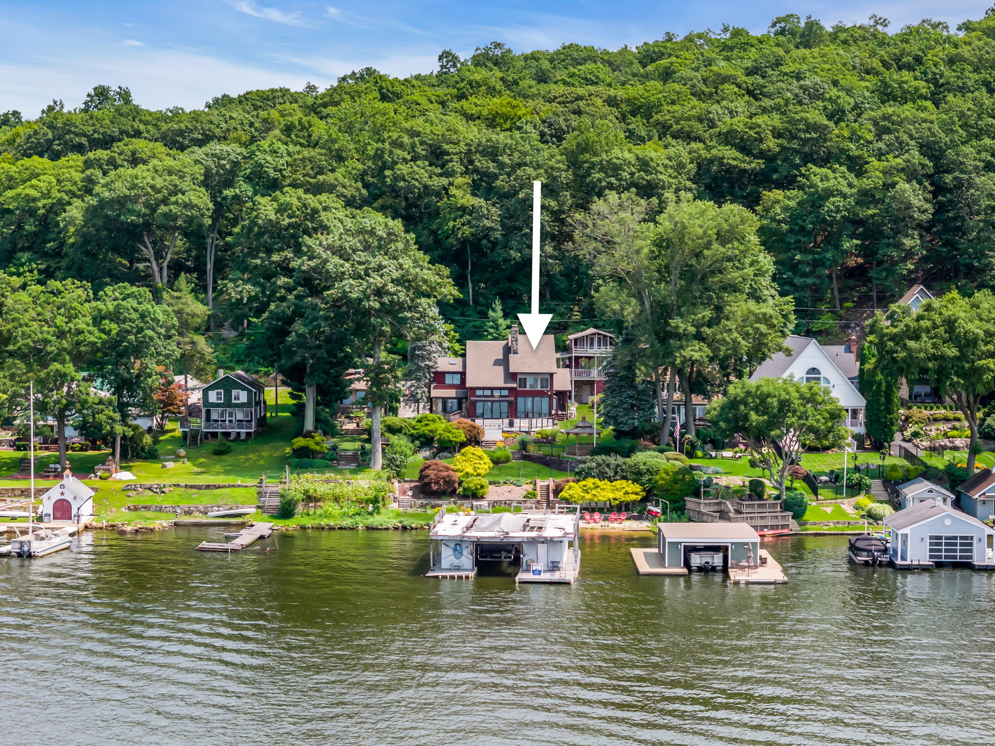 2 homes with boat house on .75 acres and 85 ft of lakefront with a private beach!