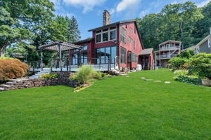 View from level open lawn back to the house and the cottage