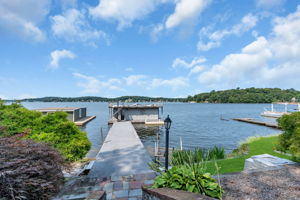 Composite decking leads to boat house with interior walk-around and storage