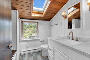 Renovated full bath with tub, shower and sky light