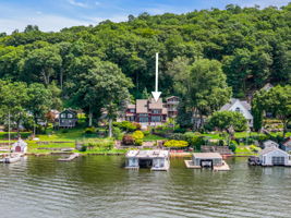 2 homes with boat house on .75 acres and 85 ft of lakefront with a private beach!