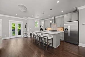 Three Sets of Glass Doors Lead to Balcony.