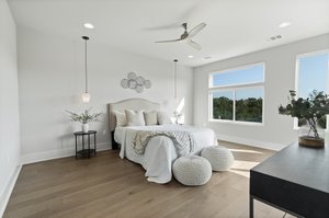 Primary Bedroom Suite w/ hardwood flooring