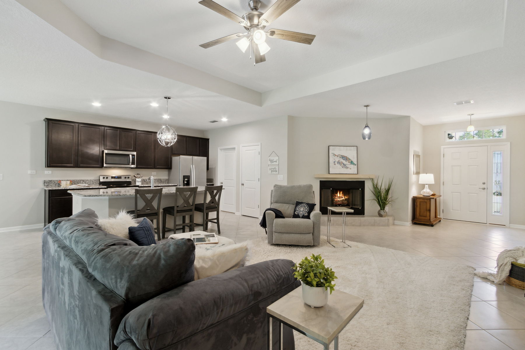 The living area opens to the kitchen and dining area ...