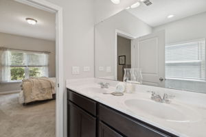 The same coffee cabinetry in the kitchen is carried through in the bathrooms...