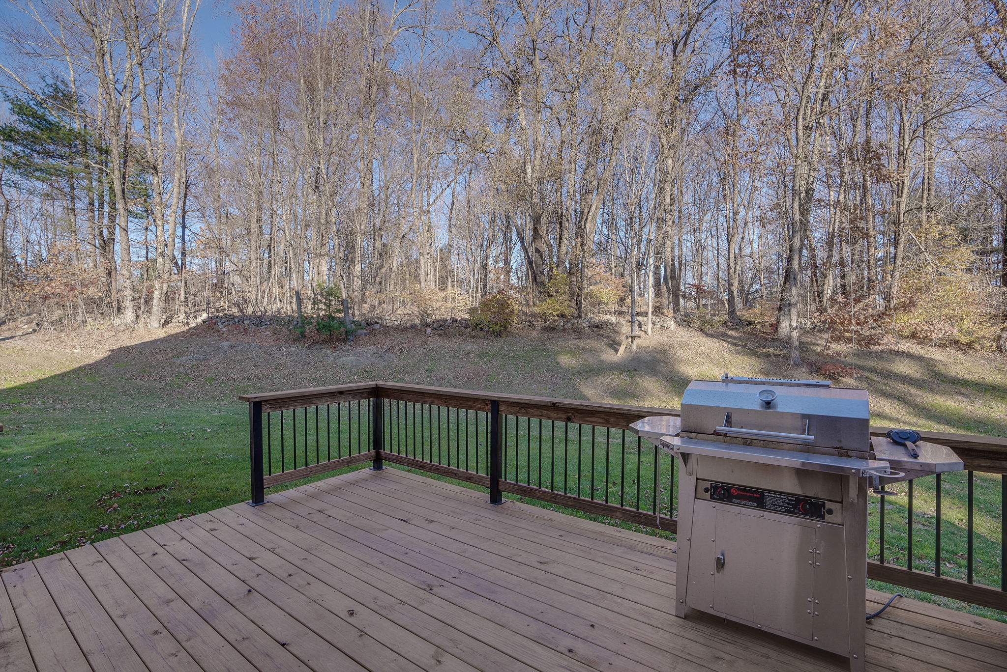 New rear deck with views of newly sodded yard and possible location for a pool or sports court