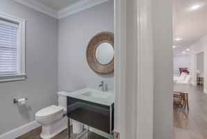 Brand new Powder Room with exceptional Robern illuminating vanity, glass top & sink, Pottery Barn mirror,  Hansgrohe faucet, and one-piece Toto toilet