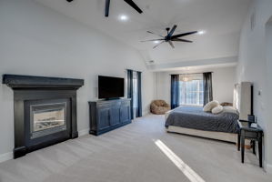 Custom Fireplace, Vaulted ceiling, and natural light are just a few highlights of this master suite