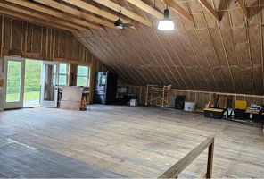 2nd Floor of barn with view toward driveway. Fully insulated and ready for your finishing style.