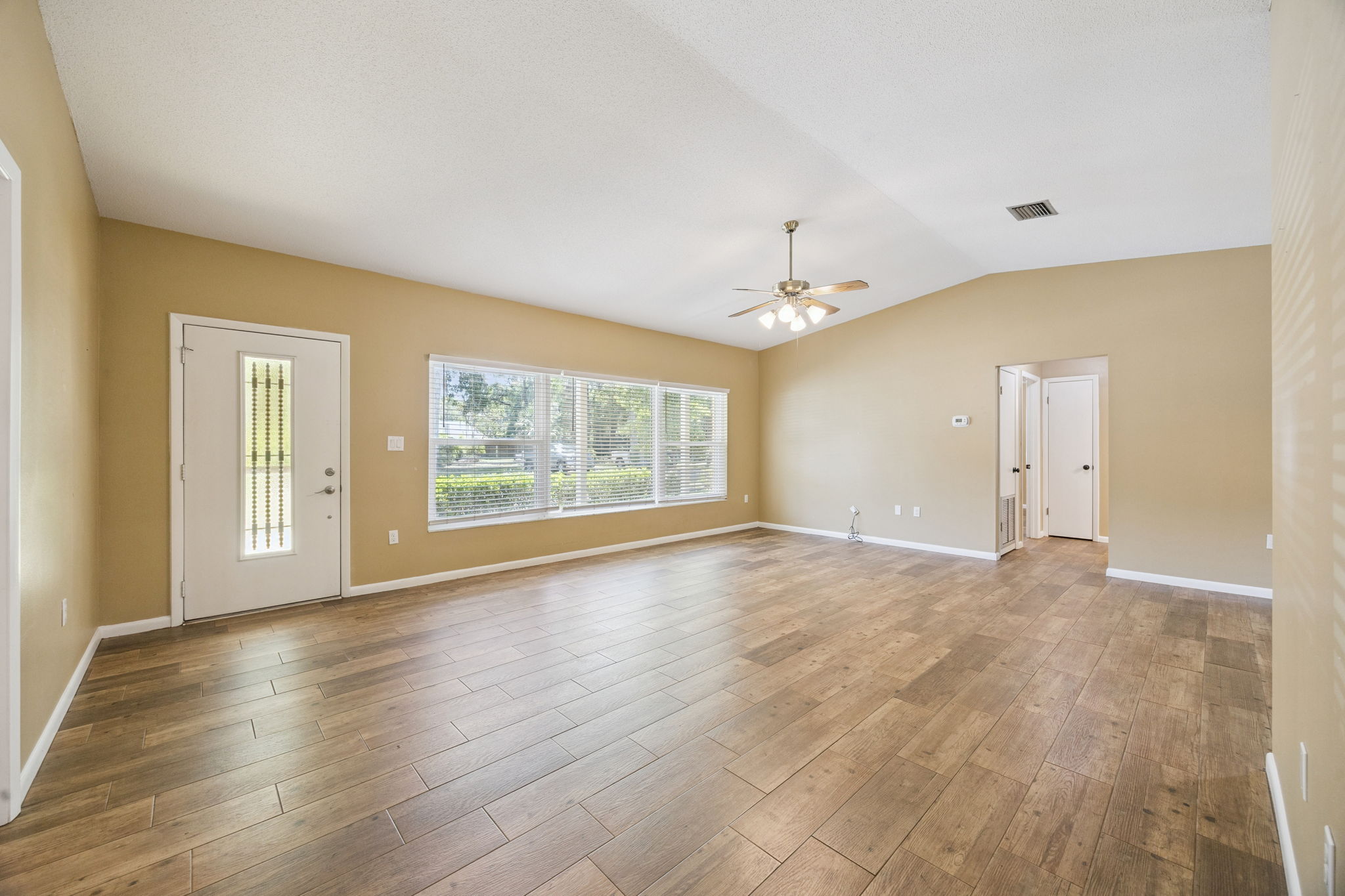Open floor plan living space with durable wood-look tile flooring