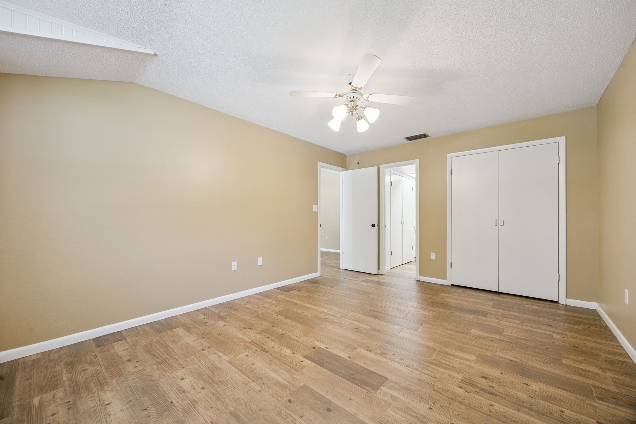 Comfortable primary bedroom with natural light and ensuite