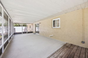 Large screened lanai with views of shaded backyard