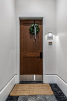 Striking wood entry door. Come inside to discover this meticulously curated home with designer finishes throughout.