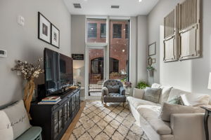 Dramatic floor to ceiling Pella windows with custom blinds.