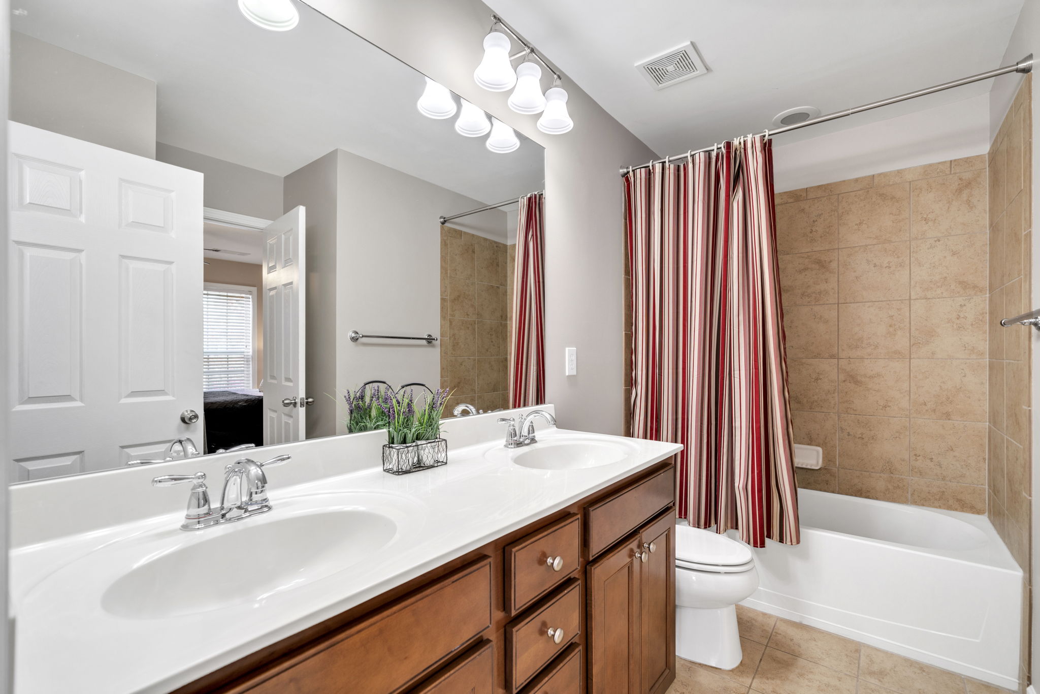 Hall Bathroom-double vanities-tile floors and tile surround
