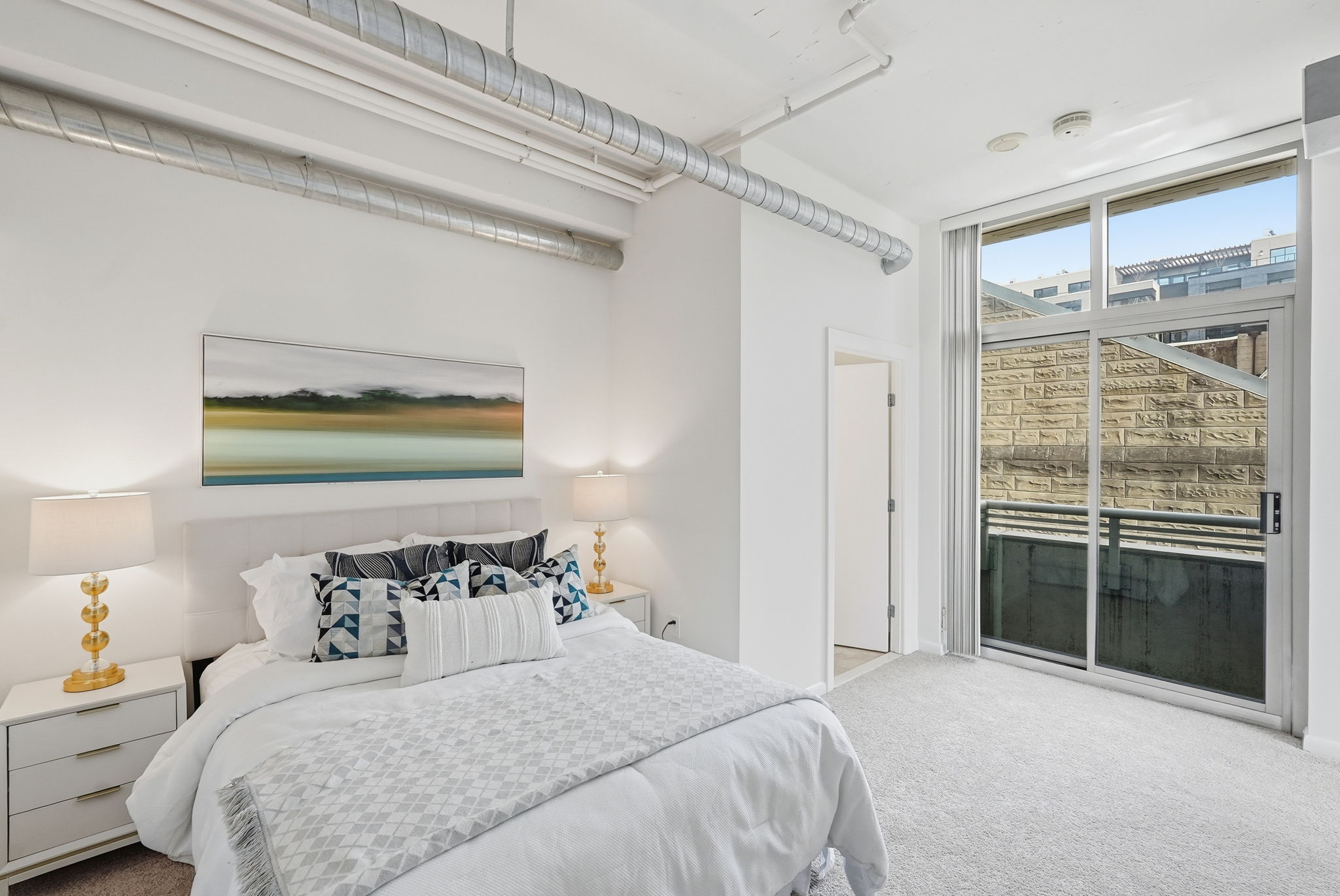 Bedroom 1 w/ Ensuite Bath and Sliding Doors to Balcony