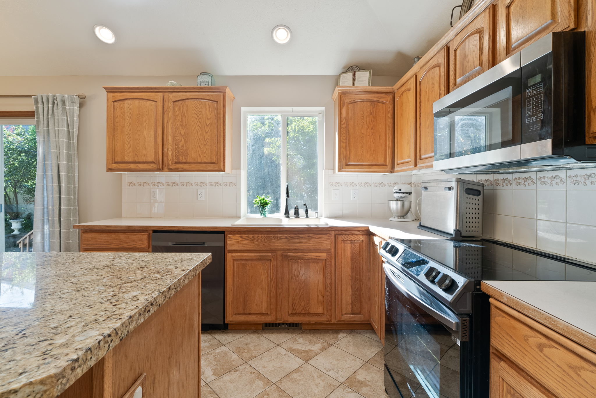 Kitchen with a view into the fenced Backyard