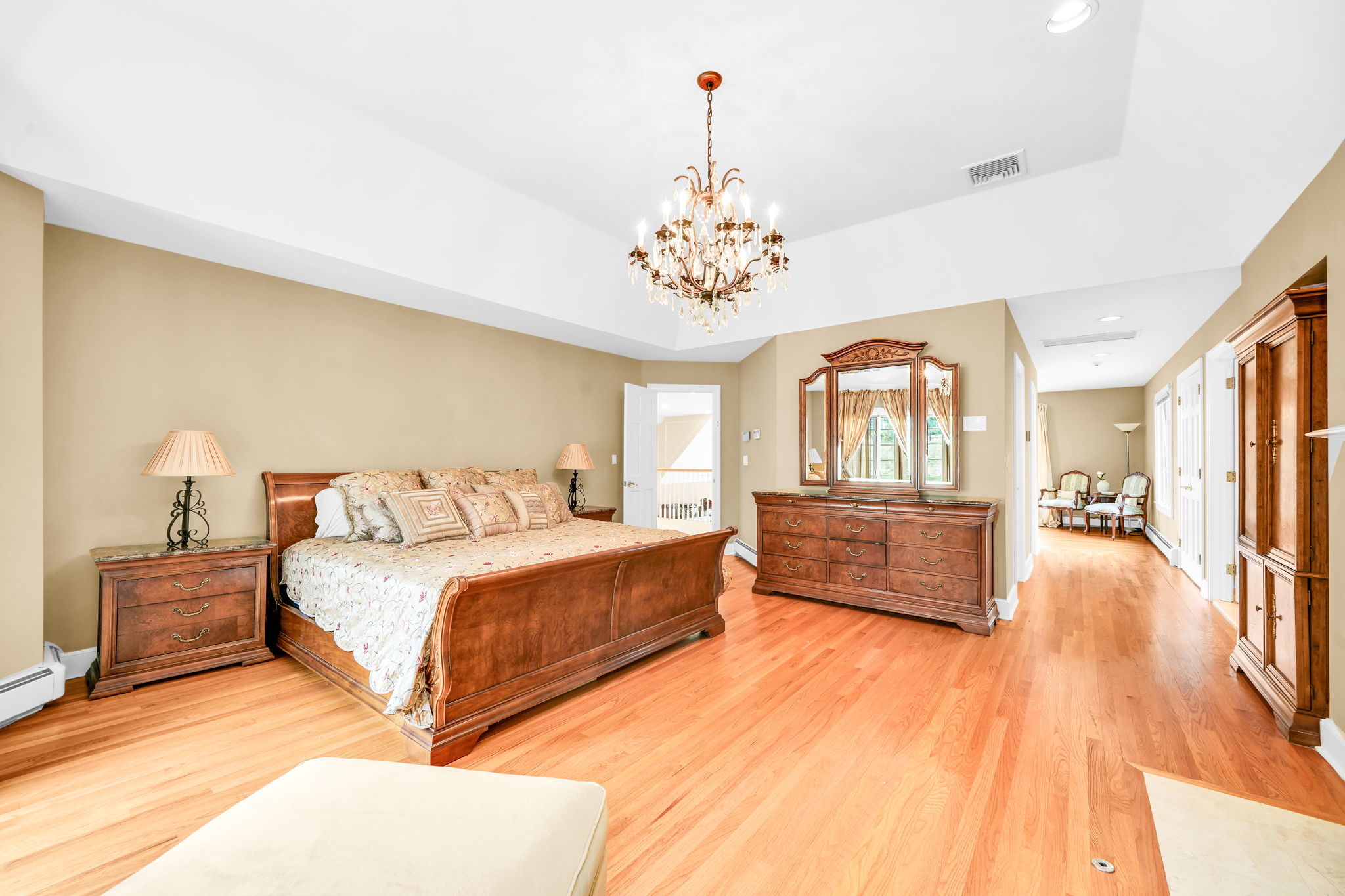 The primary suite, upstairs, is a retreat unto itself: a front bump-out adds architectural interest and extra square footage, while a walk-in closet plus a second closet handle wardrobe needs with ease. Its spa-style en-suite bath features in-floor heat, a walk-in shower, soaking tub, and bidet, along with its own fireplace, and a private sitting room or office with a balcony overlooks the sprawling backyard below.