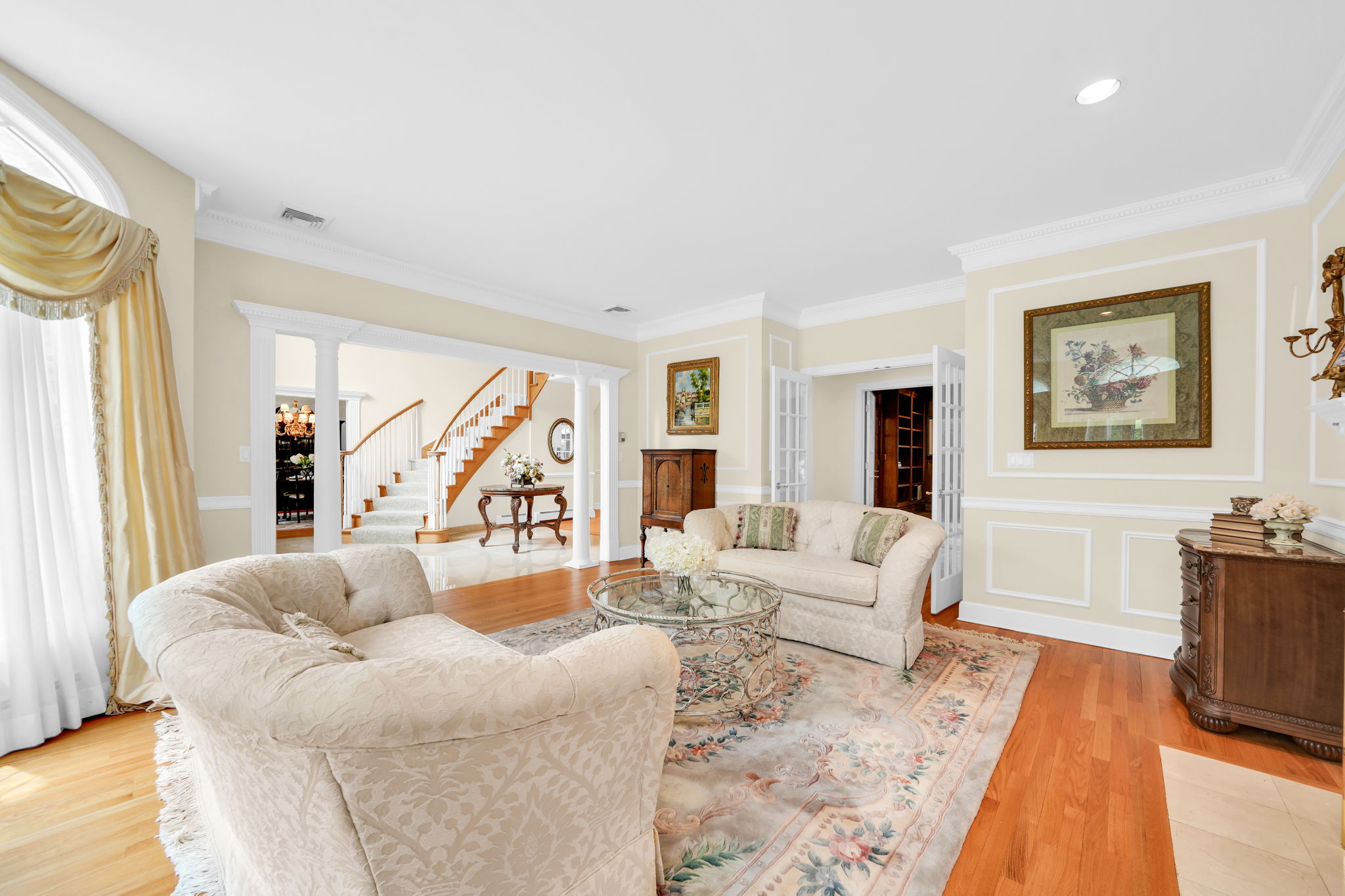 Just off the foyer, a separate living room, warmed by its own fireplace, offers even more space to gather.