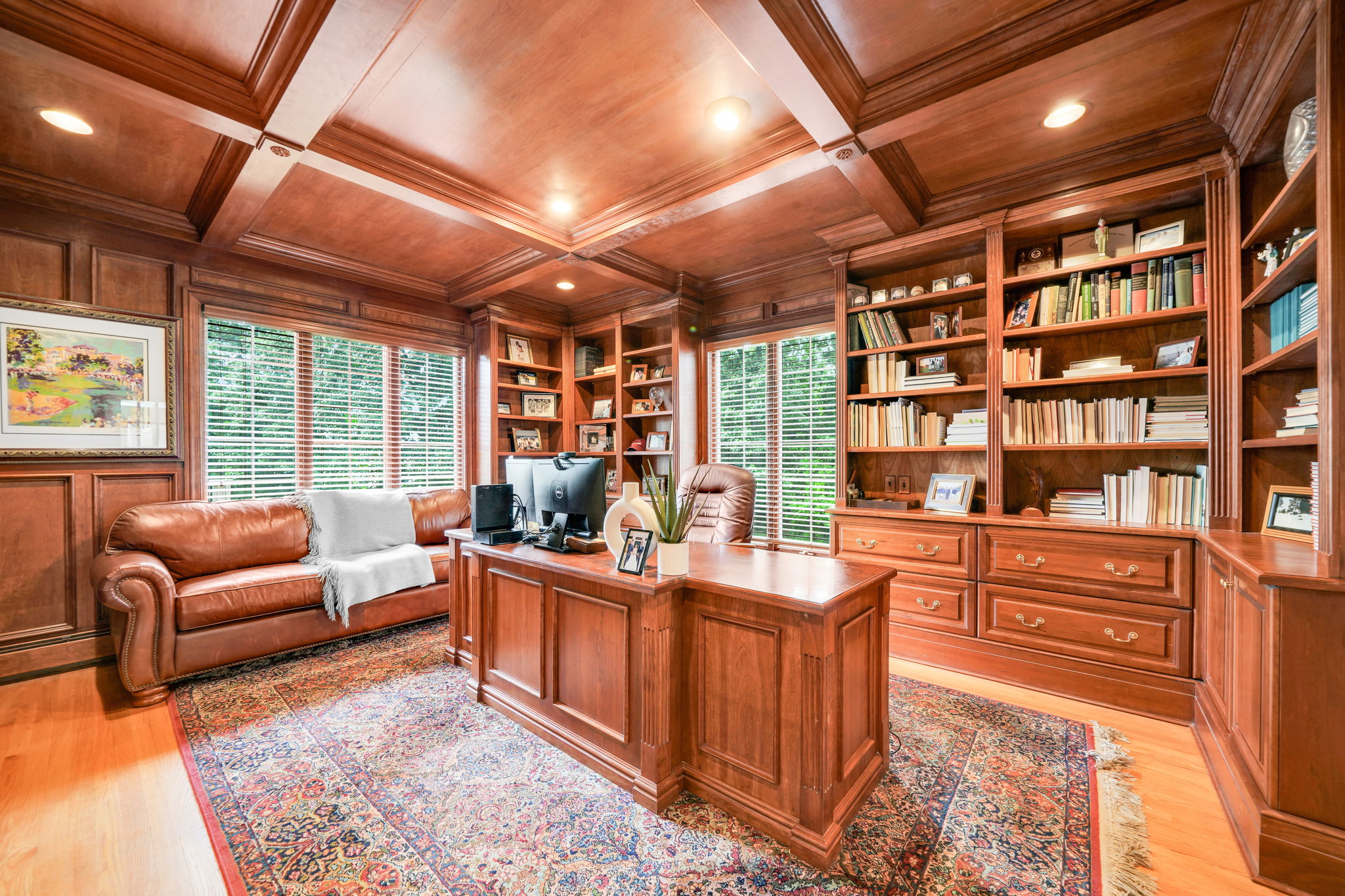 Nearby, a custom, fully cherry-trimmed study with a coffered wood ceiling and a custom desk offers a work-from-home space that feels like it belongs in a private club.